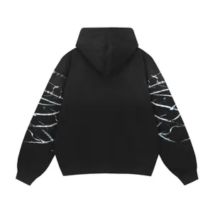Streetwear black hoodie back view featuring abstract white sleeve pattern detailed.