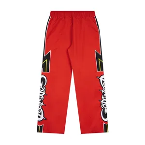 Red high street casual sweatpants with color-blocked side stripes and embroidered text.