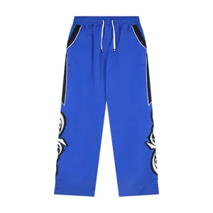 Blue high street casual track pants with side color block and embroidery detail for daily wear.