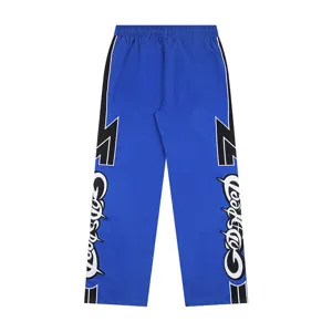 Trendy streetwear color-blocked casual pants with side graffiti embroidery and elastic waist.