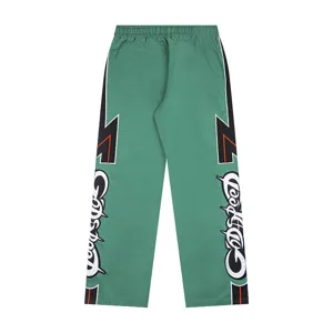 Green streetwear casual sports trousers with color-block side panels and embroidery.