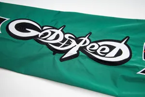 Green casual pants detail featuring bold embroidered GODSPEED lettering streetwear style.