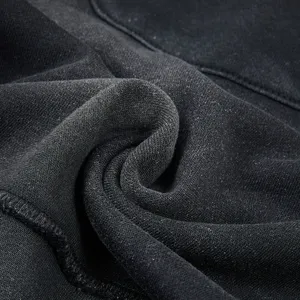 High quality washed cotton fabric texture close-up, showing heavy weight knit detail and soft hand feel.