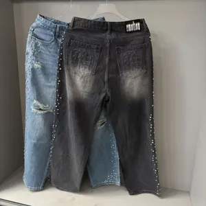High street vintage washed denim jeans with rhinestones and distressed details for men and women.
