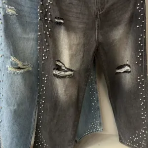 High street distressed rhinestone wash denim jeans for men and women chic pants detail.