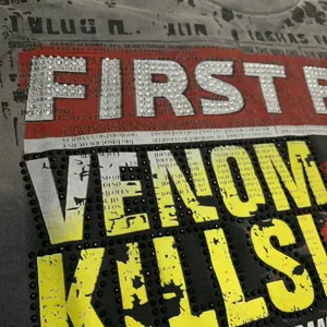 Close-up view of a stylish streetwear t-shirt featuring rhinestone and stud letter details.
