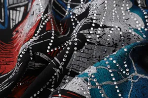 Detailed shot of trendy retro streetwear t-shirt fabric featuring sparkling hotfix rhinestones.
