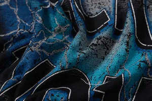 Close-up detail of washed vintage graphic streetwear t-shirt fabric texture and print.