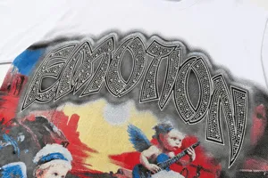 Close-up of white short sleeve t-shirt featuring front rhinestones emotion graphic print