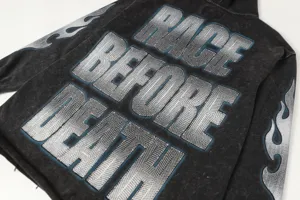 Washed grey hoodie detail featuring back text graphic and flame sleeve prints for streetwear.