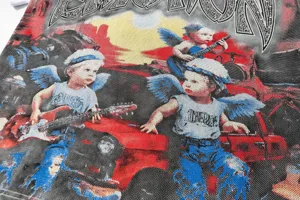 Close-up detail of vintage street style graphic t-shirt with rhinestone and woven cherub design.