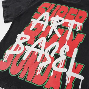 Close-up detail of vintage washed black t-shirt with graffiti graphic print streetwear style.