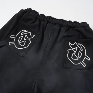 Pantaloncini casual neri lavati con ricamo bianco sulla tasca posteriore stile streetwear.