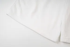 Primo piano del dettaglio dell'orlo di pantaloncini casual bianchi con cuciture.
