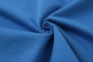 Close-up fabric texture detail of casual blue cotton textile material showing fine knit.