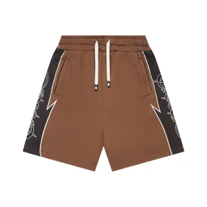 Brown streetwear shorts featuring black contrast side panels with white graphic print, elastic waist.