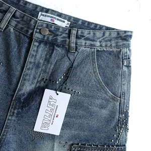 Close-up detail of vintage washed denim shorts featuring star studs and branded waist tags.
