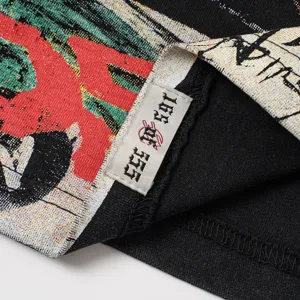 Close-up detail shot of black woven graphic t-shirt collar tag and textured fabric.