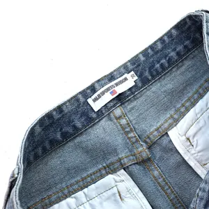 Detail shot of vintage denim shorts waistband, featuring brand label size 30 and neat stitching.