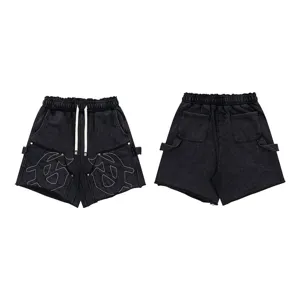 Washed black distressed casual shorts with unique embroidery and drawstring waist.