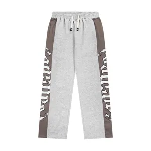 Detailed view of gothic letter embroidered colorblock sweatpants, casual streetwear style.