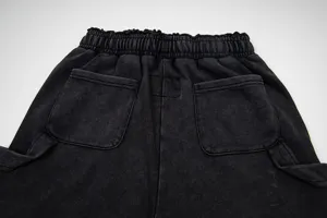 Detailed view of black washed distressed casual shorts with elastic waistband and back pockets.