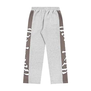 Grey casual sweatpants with brown side panels and gothic cross prints, high street style.