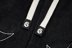 Close-up detail of black washed casual shorts with thick drawstrings and branded metal tips.