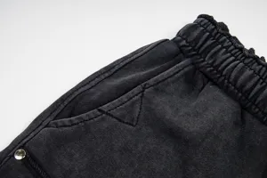 Detailed view of washed black casual shorts with elastic waistband and pocket detail.