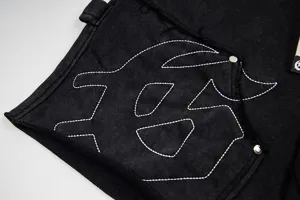 Washed distressed black casual streetwear shorts with contrast white stitching and side logo detail.