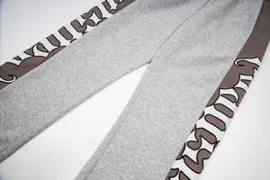 Casual streetwear sweatpants with gothic letter side stripes, unisex high street straight trousers.