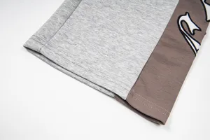 Casual color-blocked sweatpants detail with gothic embroidery for stylish streetwear outfits.