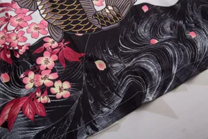 Close-up detail of Japanese ukiyo-e style koi fish and cherry blossom print fabric.