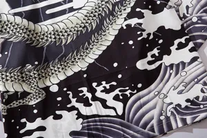 Detailed view of traditional Japanese ukiyo-e dragon and wave print 7-sleeve cardigan.