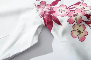Close-up view of Japanese style kimono cardigan sleeve, featuring delicate pink cherry blossom print.