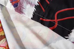 Detailed view of Japanese style cardigan fabric showcasing fine stitching and vivid printed patterns.