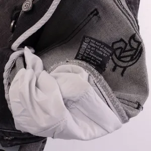 Detail shot of men women high street casual denim shorts wash label and metal button hardware