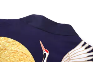 Japanese kimono detail view featuring classic crane and golden sun printed fabric.