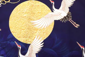 Close-up fabric detail of Japanese ukiyo-e cardigan featuring elegant white cranes and golden moon.