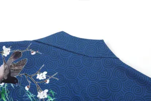 Close-up of blue Japanese kimono cardigan collar with traditional bird and floral print.