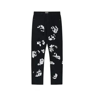 Black denim jeans featuring a bold white cotton flower graphic print. Detailed streetwear style.