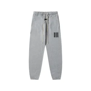 Grey streetwear sweatpants for men and women, featuring long drawstrings and a comfy jogger fit.