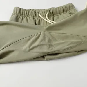 Detail shot of casual sweatpants elastic drawstring waistband and soft fabric texture closeup.