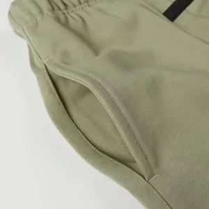 Close-up detail of pocket and waistband on casual jogger sweatpants, premium fabric texture.