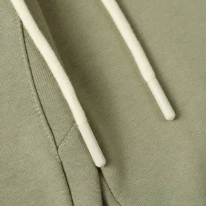 Close-up detail of olive green casual sweatpants drawstring with dipped tips for daily wear.