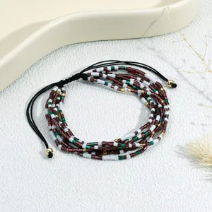 Bohemian multi-layer beaded bracelet featuring colorful glass beads and adjustable braided cord.