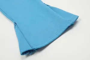 Dettaglio polsino pantaloni flared blu stile streetwear apertura inferiore zip