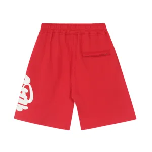 High street Y2K style red fleece shorts detail view featuring side graffiti print and pocket.
