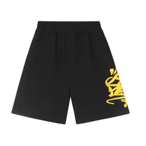 Black fleece shorts with yellow graffiti letter print, stylish streetwear Y2K casual fit.