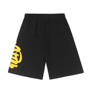 Black streetwear shorts featuring bold yellow graffiti lettering, high street Y2K style.